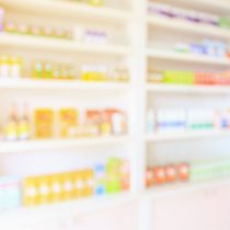 pharmacy shelves filled with medication blur background